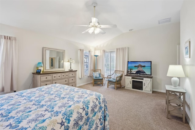 carpeted bedroom with a ceiling fan, vaulted ceiling, and baseboards