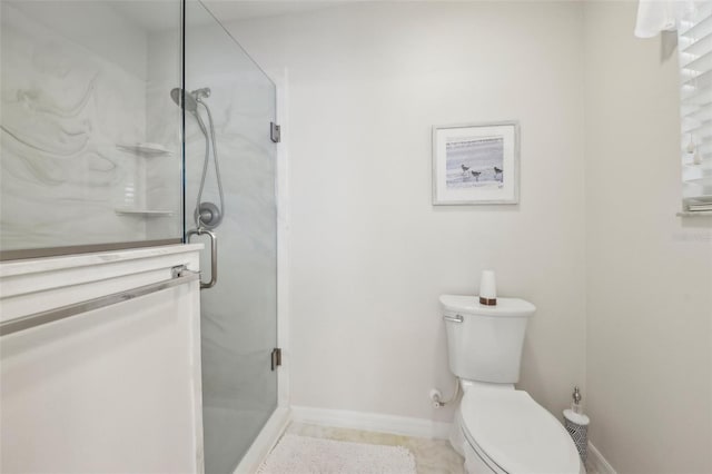 full bath with a shower stall, toilet, and baseboards