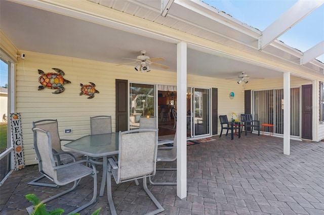 view of patio / terrace with outdoor dining area, ceiling fan, and a lanai