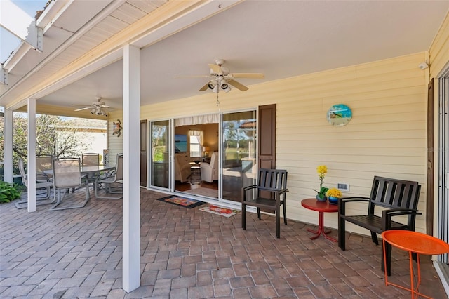 view of patio with outdoor dining area and ceiling fan