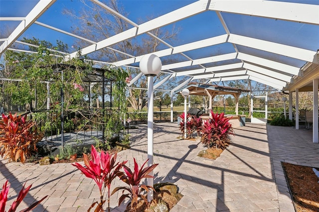 view of patio with glass enclosure