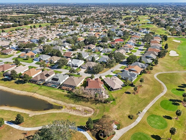 birds eye view of property with view of golf course, a water view, and a residential view