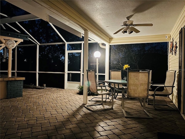 view of patio featuring a lanai and ceiling fan