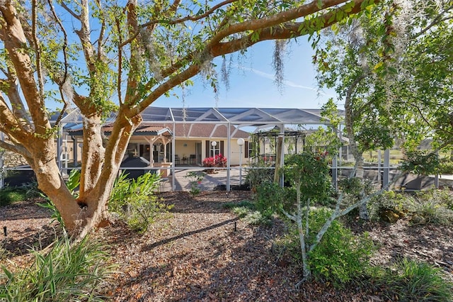 back of property featuring a lanai and a patio