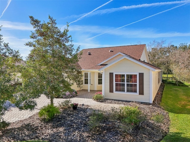 back of property featuring a shingled roof