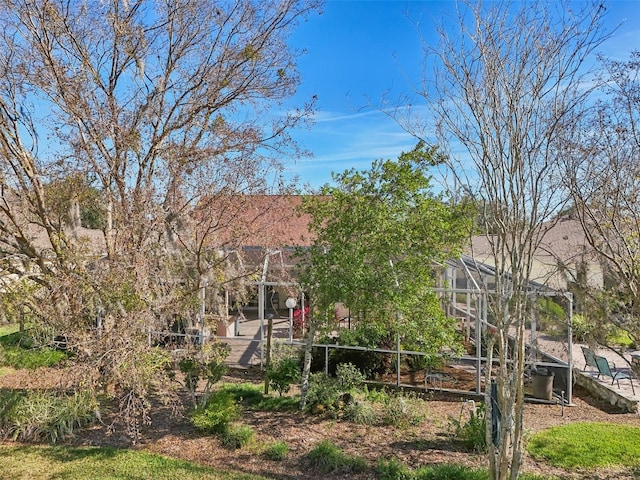 rear view of property featuring glass enclosure