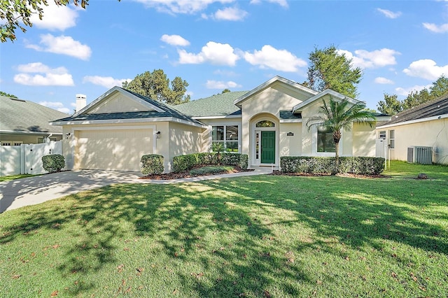 single story home featuring cooling unit, a garage, and a front yard