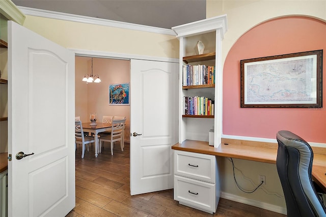 office featuring built in shelves, built in desk, a notable chandelier, and ornamental molding