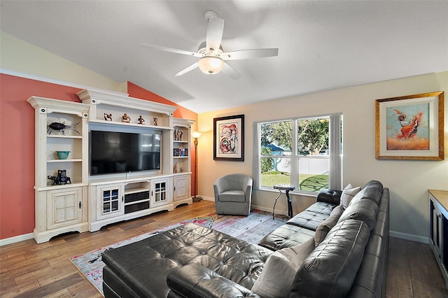 living room with hardwood / wood-style floors, vaulted ceiling, and ceiling fan