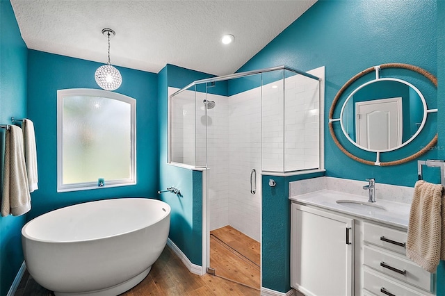 bathroom with lofted ceiling, wood-type flooring, a textured ceiling, and plus walk in shower