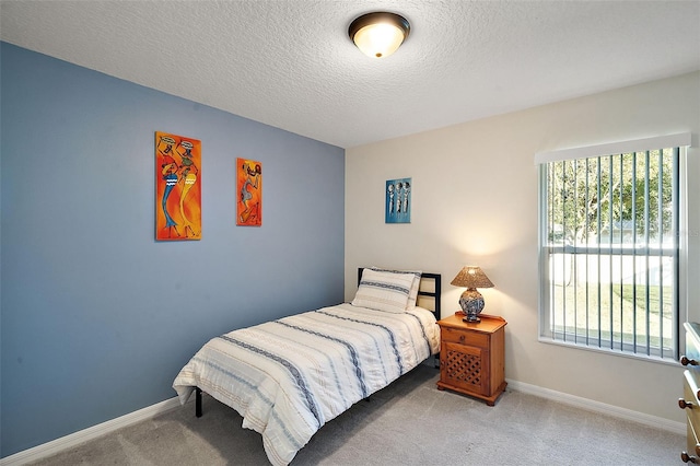 carpeted bedroom featuring a textured ceiling