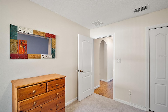 bedroom with light colored carpet