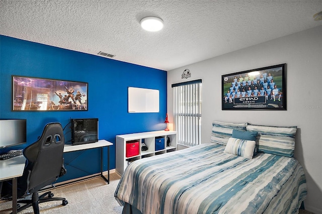 bedroom featuring carpet flooring and a textured ceiling