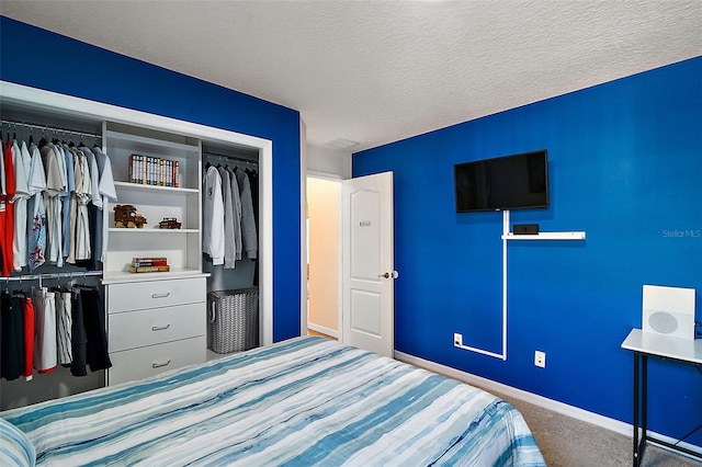 unfurnished bedroom with a textured ceiling, carpet floors, and a closet