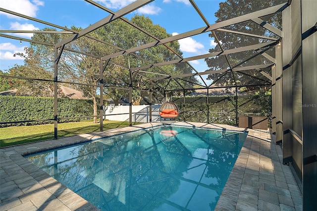 view of swimming pool featuring a lanai and a patio area