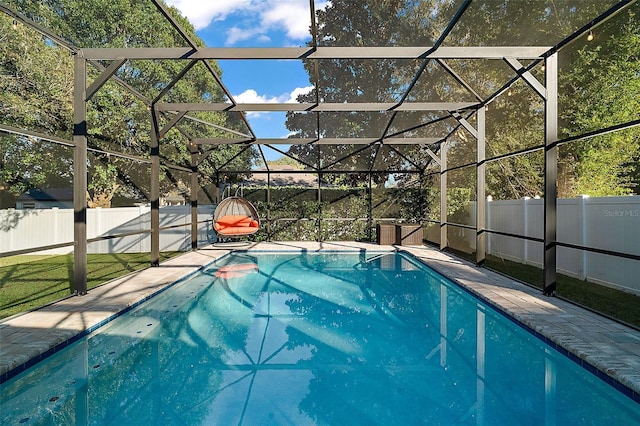 view of pool with glass enclosure