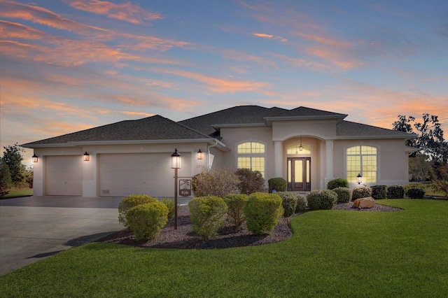 prairie-style house with a lawn and a garage