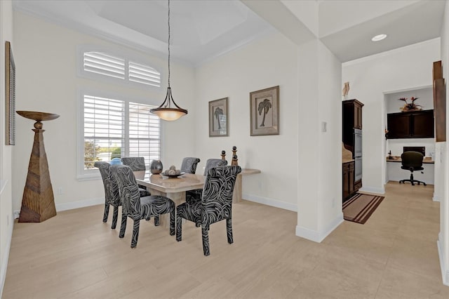 dining space featuring a towering ceiling and crown molding