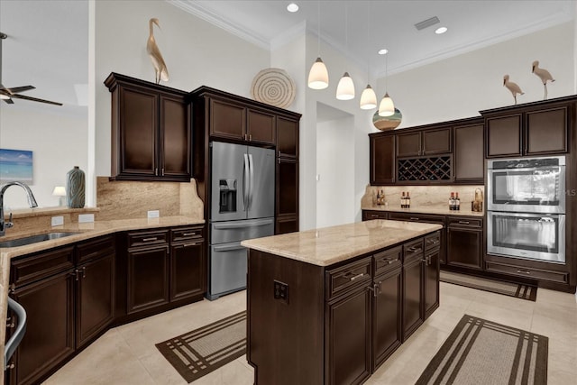 kitchen with tasteful backsplash, sink, hanging light fixtures, and appliances with stainless steel finishes