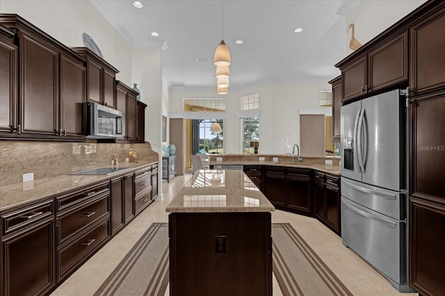 kitchen with hanging light fixtures, tasteful backsplash, dark brown cabinets, a kitchen island, and appliances with stainless steel finishes