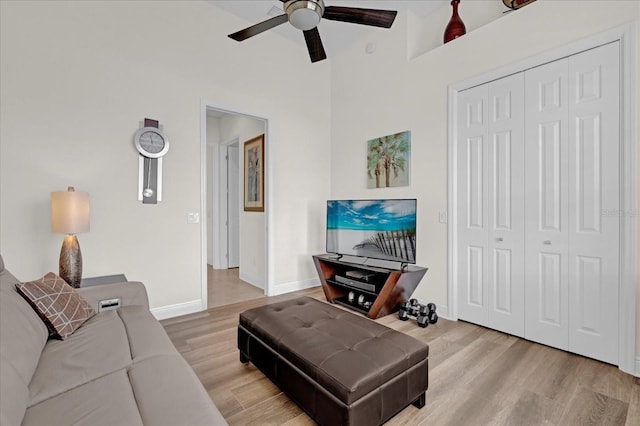 living room with ceiling fan and hardwood / wood-style flooring