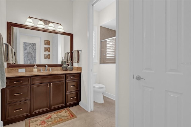 bathroom featuring tile patterned flooring, vanity, and toilet