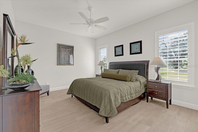 bedroom with ceiling fan and light hardwood / wood-style floors