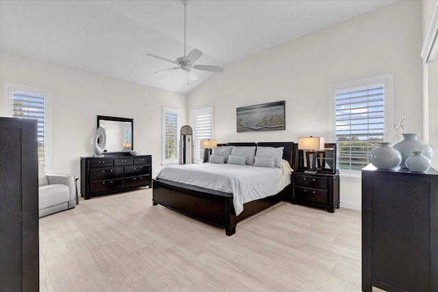 bedroom with ceiling fan, light hardwood / wood-style flooring, and lofted ceiling