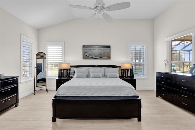 bedroom featuring light hardwood / wood-style floors, ceiling fan, and lofted ceiling