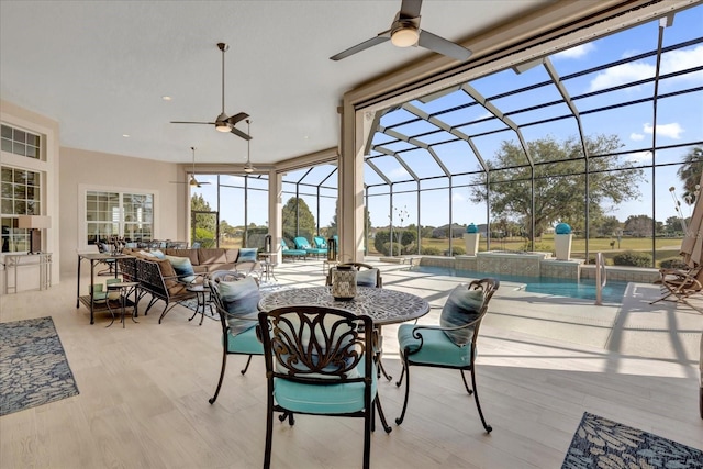 view of patio / terrace with an outdoor hangout area, glass enclosure, and ceiling fan