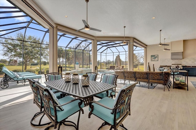 view of patio / terrace with ceiling fan, a lanai, and an outdoor hangout area