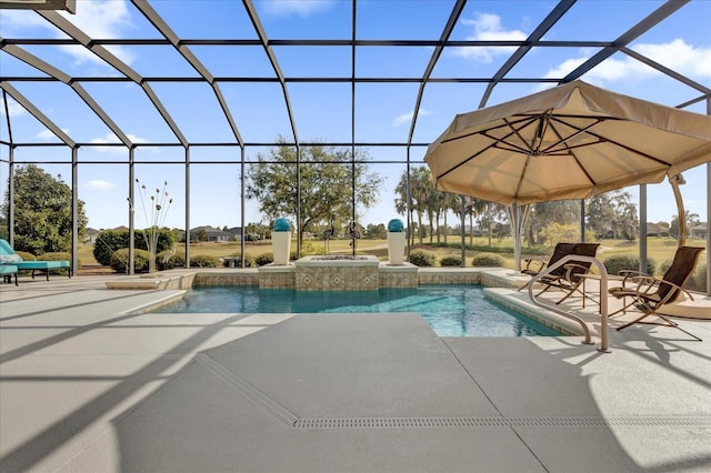 view of pool with glass enclosure and a patio