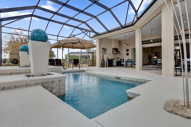 view of pool with a lanai, a patio area, and ceiling fan