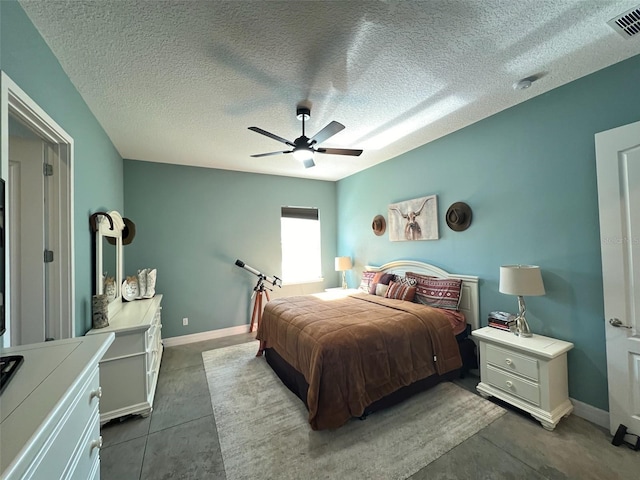 bedroom with concrete flooring, a textured ceiling, and ceiling fan