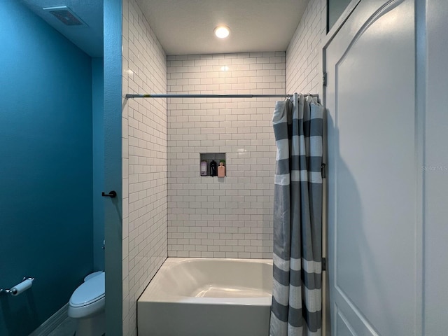 bathroom with shower / bath combination with curtain and toilet