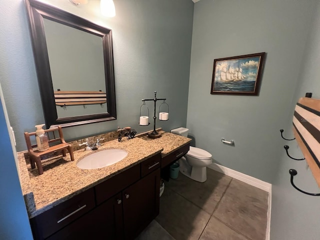 bathroom featuring tile patterned flooring, vanity, and toilet