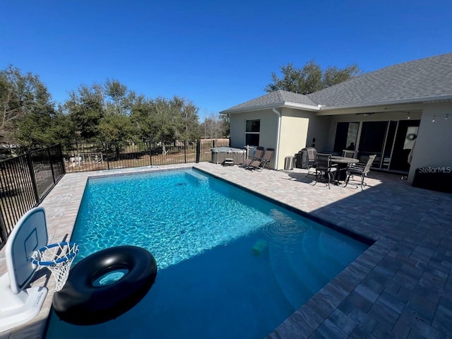 view of pool with a patio and a hot tub