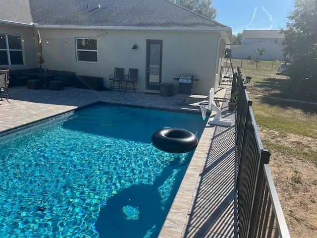 view of swimming pool featuring grilling area and a patio