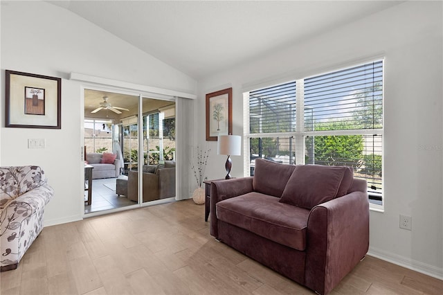 living room with vaulted ceiling, light hardwood / wood-style flooring, and a wealth of natural light