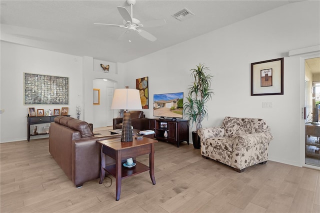 living room featuring ceiling fan and light hardwood / wood-style flooring