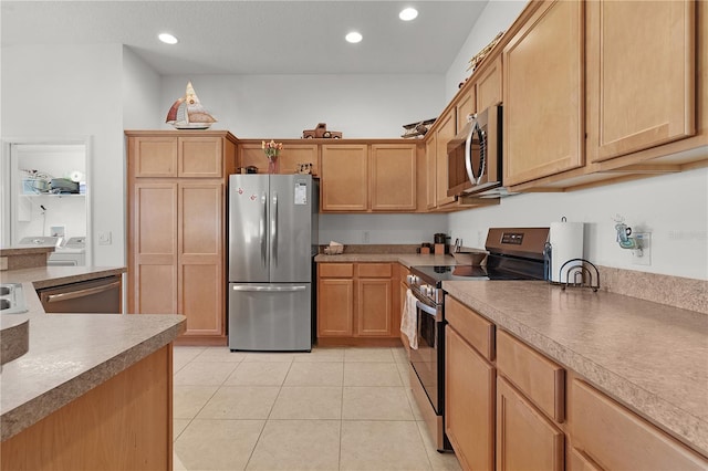 kitchen featuring light tile patterned flooring and stainless steel appliances