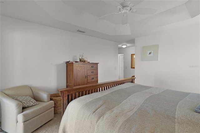 bedroom with a raised ceiling and ceiling fan