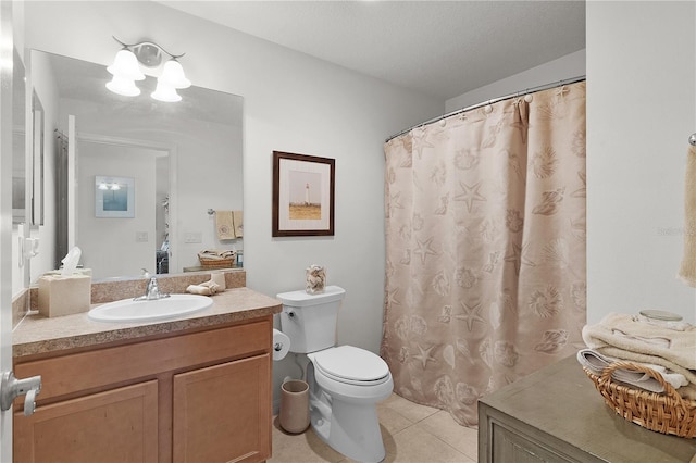 bathroom featuring tile patterned flooring, a textured ceiling, vanity, and toilet