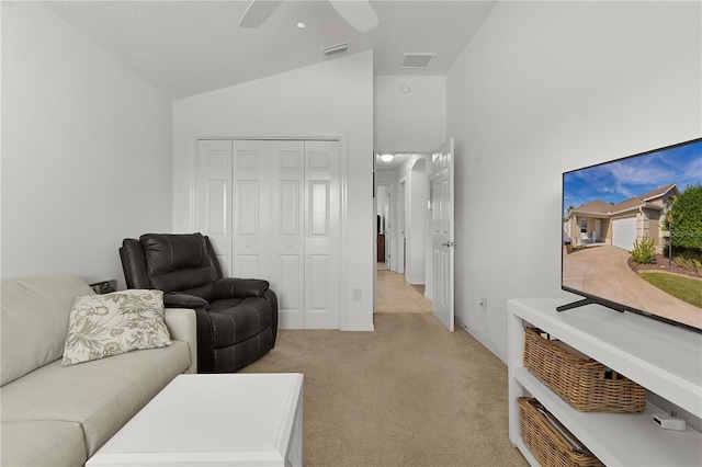 carpeted living room featuring ceiling fan and lofted ceiling