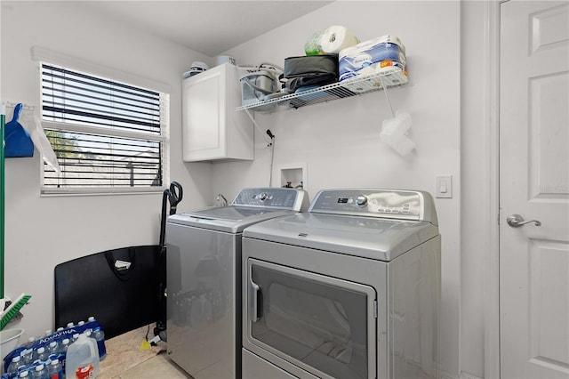 washroom featuring cabinets and separate washer and dryer