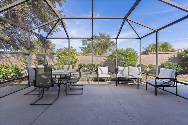 view of patio featuring glass enclosure