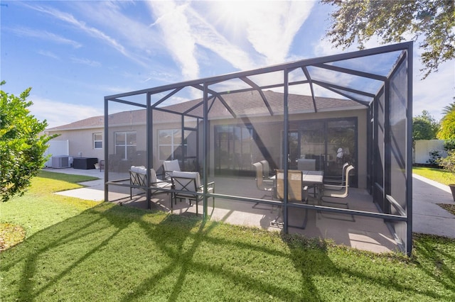 back of house featuring a patio area, a lanai, a yard, and cooling unit