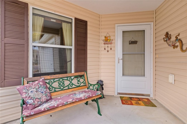 view of exterior entry with covered porch