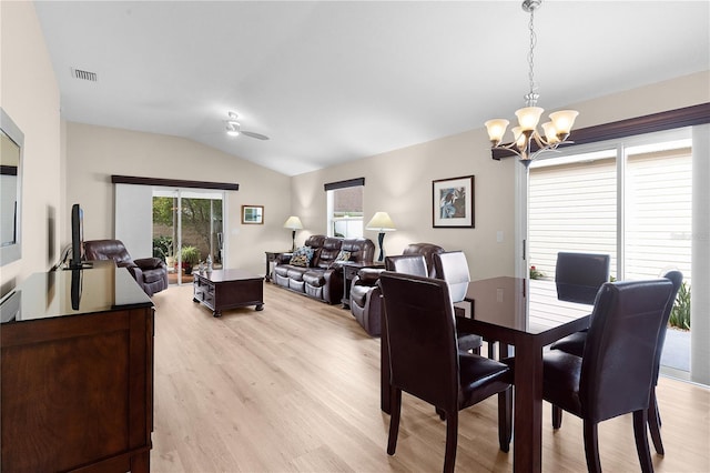 dining area with vaulted ceiling, light hardwood / wood-style flooring, and ceiling fan with notable chandelier