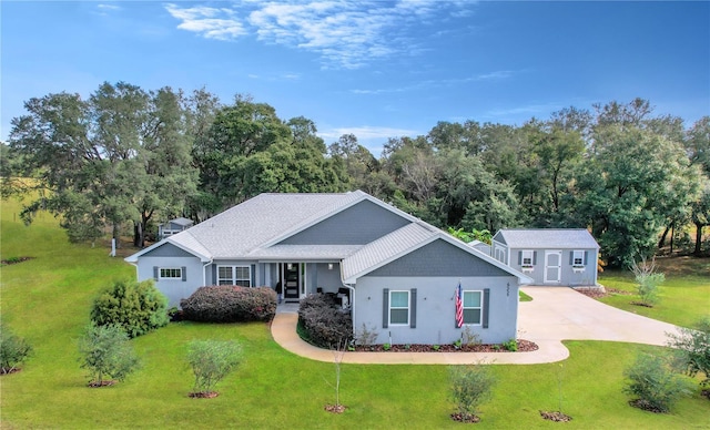 view of front of home with a front lawn and an outdoor structure